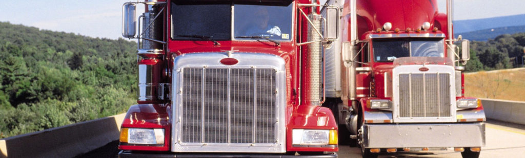 A red truck with its front end open.