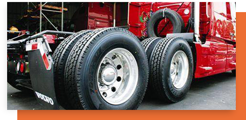 A group of tires sitting on top of a truck.